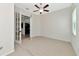 Bedroom features French doors, ceiling fan, neutral walls, and carpet at 13026 Ramblewood Trl, Bradenton, FL 34211