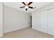 Bright bedroom features neutral walls, carpet, ceiling fan, and large closet at 13026 Ramblewood Trl, Bradenton, FL 34211