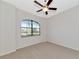 Bright bedroom features neutral walls, carpet, and a large window at 13026 Ramblewood Trl, Bradenton, FL 34211