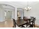 Light and bright dining room with a chandelier, arched doorways, and easy access to other living spaces at 13026 Ramblewood Trl, Bradenton, FL 34211