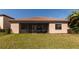 View of the home's exterior featuring a screened lanai and landscaped yard at 13026 Ramblewood Trl, Bradenton, FL 34211