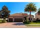 Charming single-Gathering home with a well-manicured lawn, paver driveway, and three-car garage at 13026 Ramblewood Trl, Bradenton, FL 34211