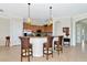 Bright kitchen with barstool seating, stainless appliances, and granite countertops offers a welcoming space for cooking and dining at 13026 Ramblewood Trl, Bradenton, FL 34211