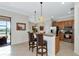 The open concept kitchen features barstool seating, stainless appliances, and views to the lanai at 13026 Ramblewood Trl, Bradenton, FL 34211
