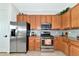 This kitchen features stainless steel appliances, granite countertops, and plenty of cabinet storage space at 13026 Ramblewood Trl, Bradenton, FL 34211