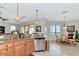 Bright kitchen area with stainless steel appliances and a view to the dining area at 13026 Ramblewood Trl, Bradenton, FL 34211