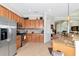This lovely kitchen features stainless steel appliances, granite countertops, and ample cabinet space for storage at 13026 Ramblewood Trl, Bradenton, FL 34211
