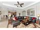 Cozy living room features a leather sectional sofa, a decorative rug, and an arched opening to other living spaces at 13026 Ramblewood Trl, Bradenton, FL 34211