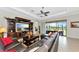 The living room is furnished with a media center, a ceiling fan, and a comfortable leather sectional sofa at 13026 Ramblewood Trl, Bradenton, FL 34211