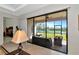 Screened in patio features outdoor furniture and beautiful lake views at 13026 Ramblewood Trl, Bradenton, FL 34211