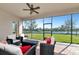 The screened patio features nice outdoor furniture, beautiful view of the lake at 13026 Ramblewood Trl, Bradenton, FL 34211