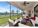 Relax on this screened-in patio with views of the lake and comfortable seating at 13026 Ramblewood Trl, Bradenton, FL 34211