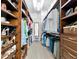Spacious walk-in closet with shelving, drawers, and a full-length mirror at 13026 Ramblewood Trl, Bradenton, FL 34211