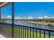 Scenic water view from the screened lanai, overlooking the lush landscaping and blue water at 13714 Messina Loop # 202, Bradenton, FL 34211