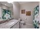 Bathroom featuring a granite vanity countertop and a bathtub with a tropical leaf shower curtain at 13714 Messina Loop # 202, Bradenton, FL 34211
