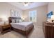 Bedroom features natural light, comfortable bed, and stylish furnishings at 13714 Messina Loop # 202, Bradenton, FL 34211