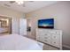 Bedroom with TV, dresser, and access to the ensuite bathroom and another room at 13714 Messina Loop # 202, Bradenton, FL 34211
