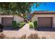Charming townhomes with paver driveway and two-car garages, framed by lush landscaping at 13714 Messina Loop # 202, Bradenton, FL 34211