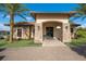 Charming building entrance with stone accents, manicured landscaping, and paver walkway at 13714 Messina Loop # 202, Bradenton, FL 34211