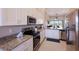 Modern kitchen featuring stainless steel appliances and granite countertops at 13714 Messina Loop # 202, Bradenton, FL 34211