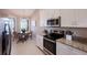 Stylish kitchen with stainless steel appliances, granite countertops, and a cozy breakfast nook at 13714 Messina Loop # 202, Bradenton, FL 34211