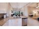 Open-concept kitchen with stainless steel appliances and spacious granite island flows into living area at 13714 Messina Loop # 202, Bradenton, FL 34211