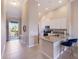 Bright, open kitchen with granite countertops, stainless appliances, and bar seating leading to balcony at 13714 Messina Loop # 202, Bradenton, FL 34211