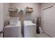 Functional laundry room with washer, dryer, shelving, and storage solutions at 13714 Messina Loop # 202, Bradenton, FL 34211