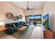 Cozy living room featuring a blue sectional sofa, decorative wall shelves, and access to a scenic lanai at 13714 Messina Loop # 202, Bradenton, FL 34211