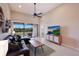 Bright living room featuring a comfortable sectional sofa, modern TV, and a view of the lanai at 13714 Messina Loop # 202, Bradenton, FL 34211