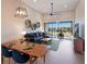Living and dining area with modern decor, ceiling fan, and sliding glass doors to a lanai with a view at 13714 Messina Loop # 202, Bradenton, FL 34211