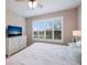 Cozy main bedroom with natural light, a TV, and a dresser, offering a serene and comfortable space at 13714 Messina Loop # 202, Bradenton, FL 34211