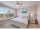 Bright and airy main bedroom featuring a large window, ceiling fan, and a well-lit ambiance at 13714 Messina Loop # 202, Bradenton, FL 34211