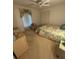 Cozy bedroom with a twin bed, a window with curtains, and neutral decor, ideal for restful nights at 1725 Briar Creek Ln, Sarasota, FL 34235