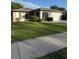 Single story home featuring manicured lawn and a two car garage, providing ample curb appeal at 1725 Briar Creek Ln, Sarasota, FL 34235