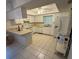 Bright kitchen featuring white cabinets, modern appliances, and tile flooring at 1725 Briar Creek Ln, Sarasota, FL 34235