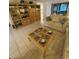 Cozy living room with comfortable seating, a beautiful display cabinet, and tile flooring at 1725 Briar Creek Ln, Sarasota, FL 34235