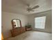 Sunlit main bedroom featuring a dresser, a large window, and neutral decor, creating a relaxing space at 1725 Briar Creek Ln, Sarasota, FL 34235