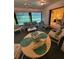 Bright sunroom with comfortable seating and a round table, perfect for relaxation and enjoying the view at 1725 Briar Creek Ln, Sarasota, FL 34235