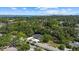 Aerial view of the property with a lush tree canopy and close proximity to the water at 1857 Siesta Dr, Sarasota, FL 34239
