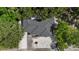 Aerial top-down view of the property showing driveway and mature landscaping at 1857 Siesta Dr, Sarasota, FL 34239