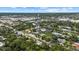 Aerial view of the property showcasing mature trees, neighborhood, and commercial district at 1857 Siesta Dr, Sarasota, FL 34239