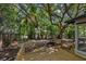 Private backyard deck surrounded by lush trees and landscaping at 1857 Siesta Dr, Sarasota, FL 34239