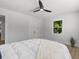 Bedroom with modern ceiling fan, bright natural light, double-door closet, and windows showing trees and sky at 1857 Siesta Dr, Sarasota, FL 34239