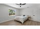 Bright bedroom features modern ceiling fan, wood floors, and natural light at 1857 Siesta Dr, Sarasota, FL 34239