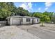 Charming single-story home featuring a well-maintained white exterior, a front yard, and a single car garage at 1857 Siesta Dr, Sarasota, FL 34239