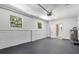 Spacious garage features painted brick, and ample space for parking and storage at 1857 Siesta Dr, Sarasota, FL 34239