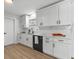The kitchen features white cabinets, sleek countertops, and a modern design, ideal for culinary enthusiasts at 1857 Siesta Dr, Sarasota, FL 34239