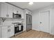 Modern kitchen featuring white cabinets, stainless steel appliances, and stylish countertops for cooking at 1857 Siesta Dr, Sarasota, FL 34239