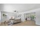 Bright living room with neutral tones, wood flooring and lots of natural light creating a relaxing atmosphere at 1857 Siesta Dr, Sarasota, FL 34239